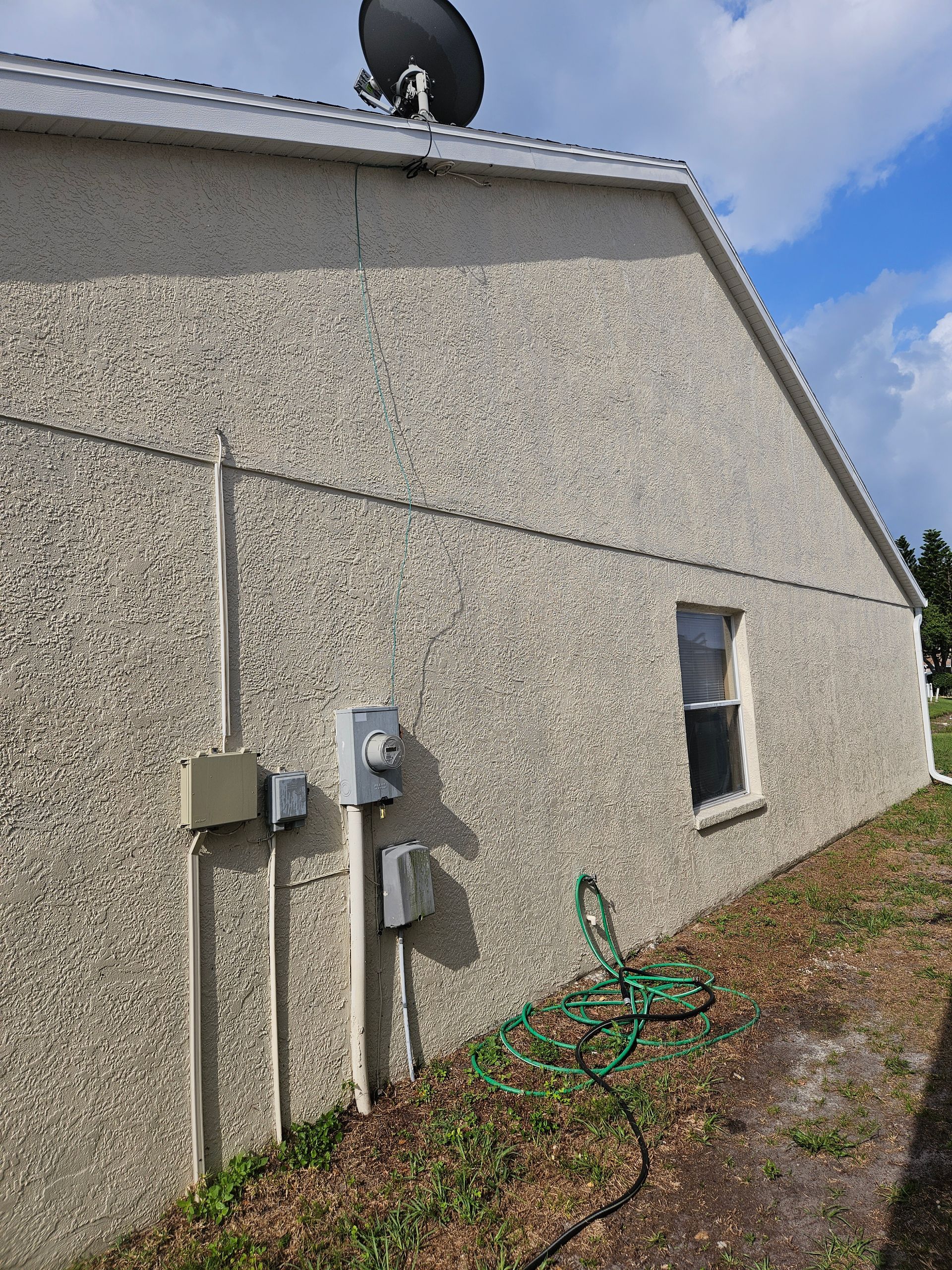 A house with a satellite dish on top of it.