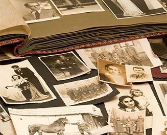 A black and white photo album filled with pictures of people and animals