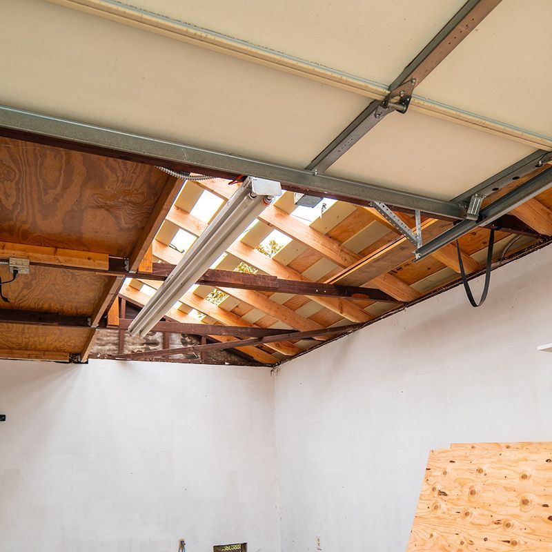 A garage with a wooden ceiling and a white wall