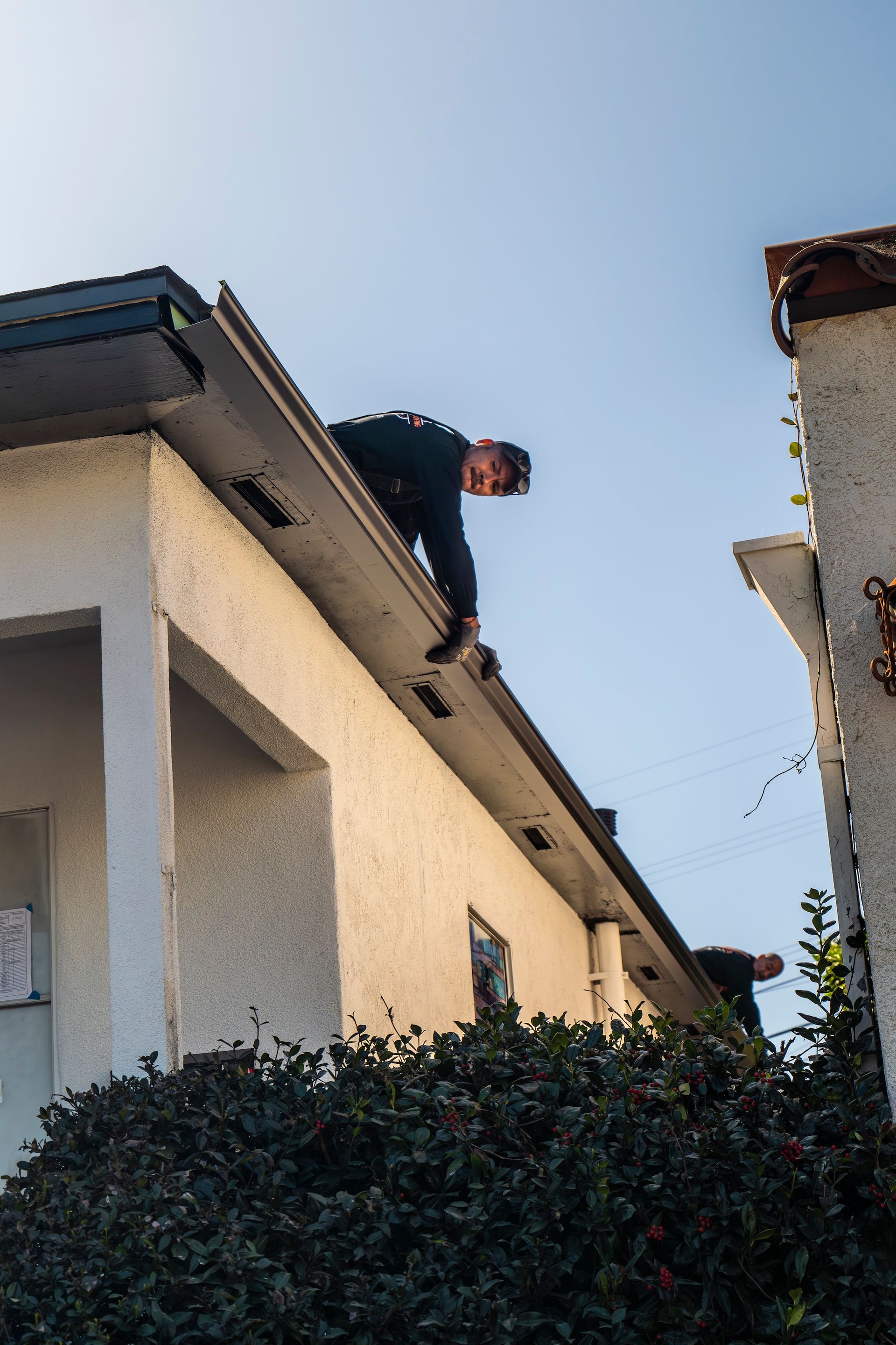 A man is standing on the roof of a building.
