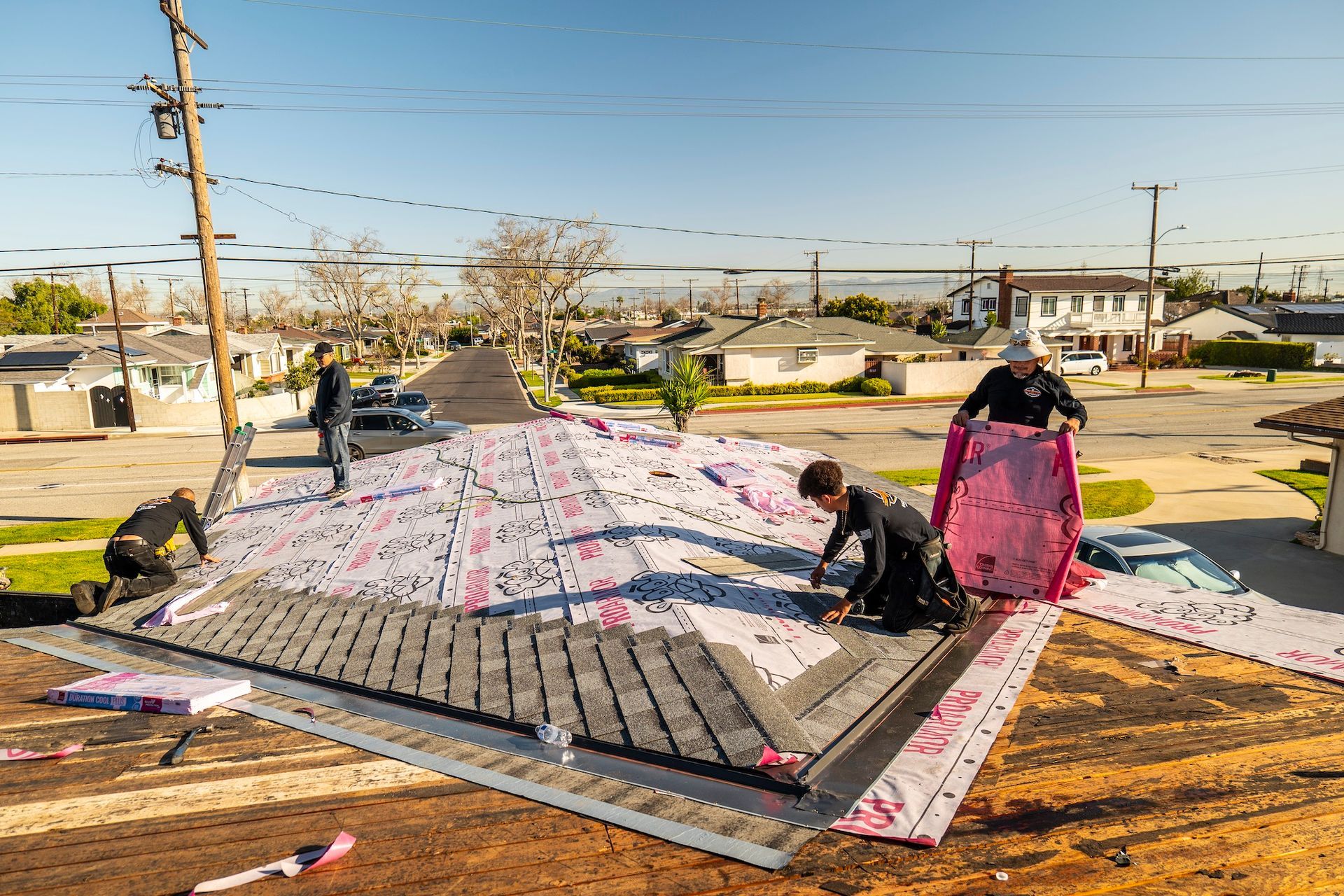 A group of people are working on a roof.