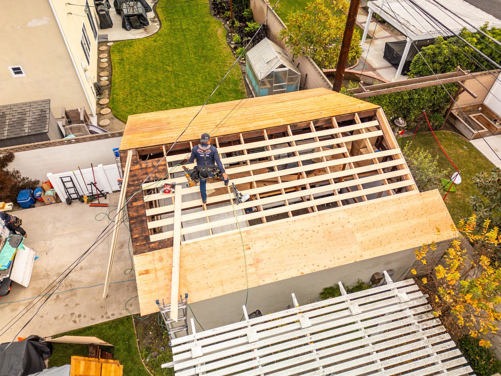 An aerial view of a roof being built on a house.