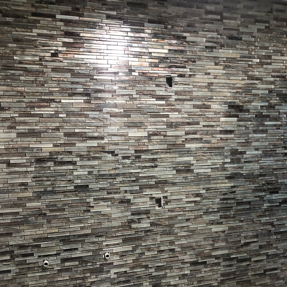 a close up of a brick wall with a light shining through it .