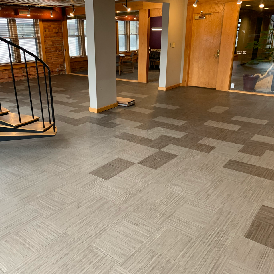 A room with a spiral staircase and a carpeted floor