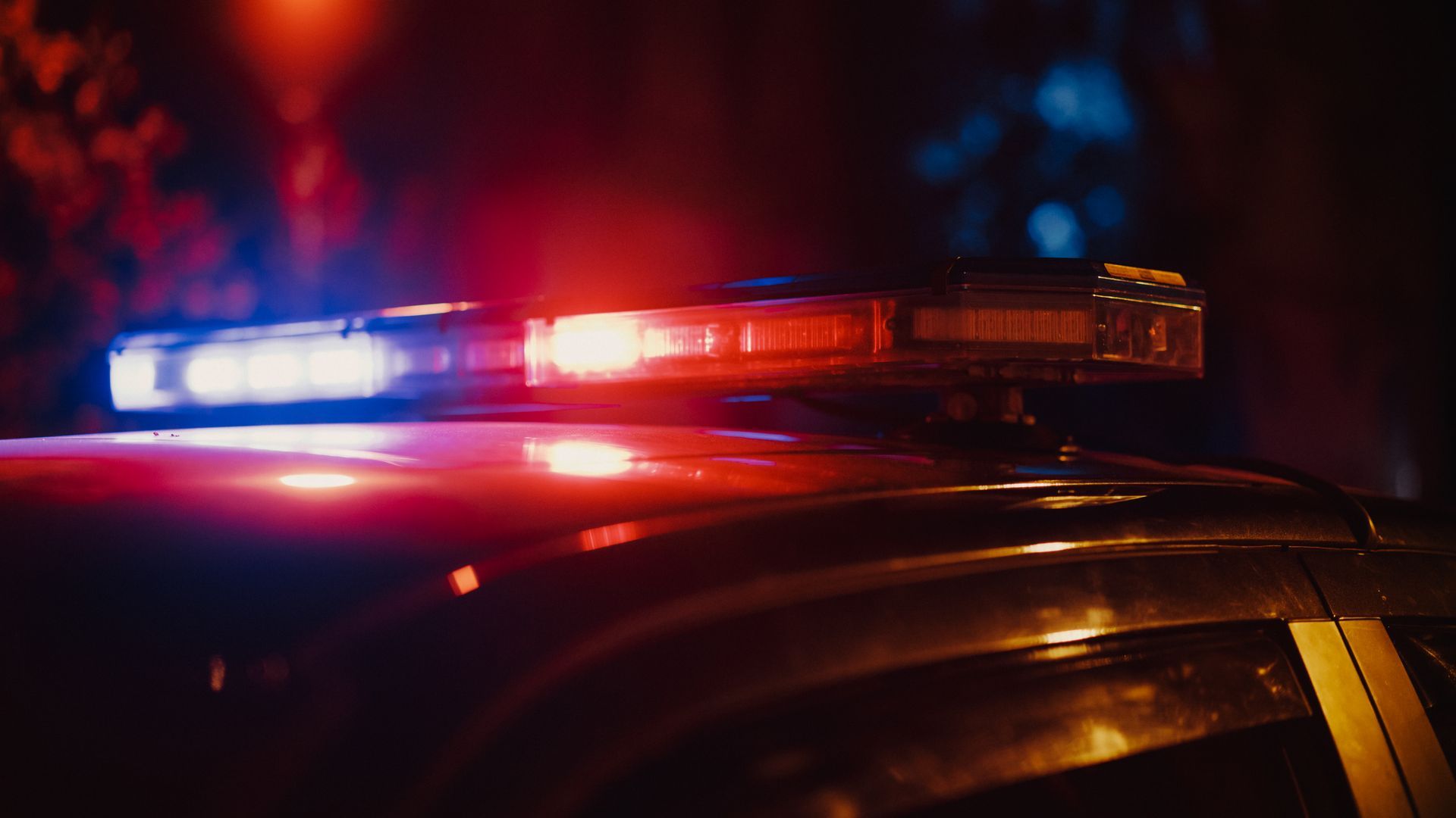 A close up of a police car 's lights at night.