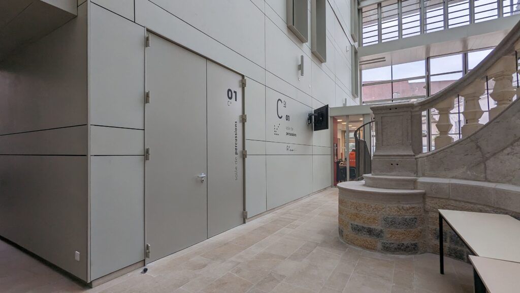 A long hallway with a staircase in the background