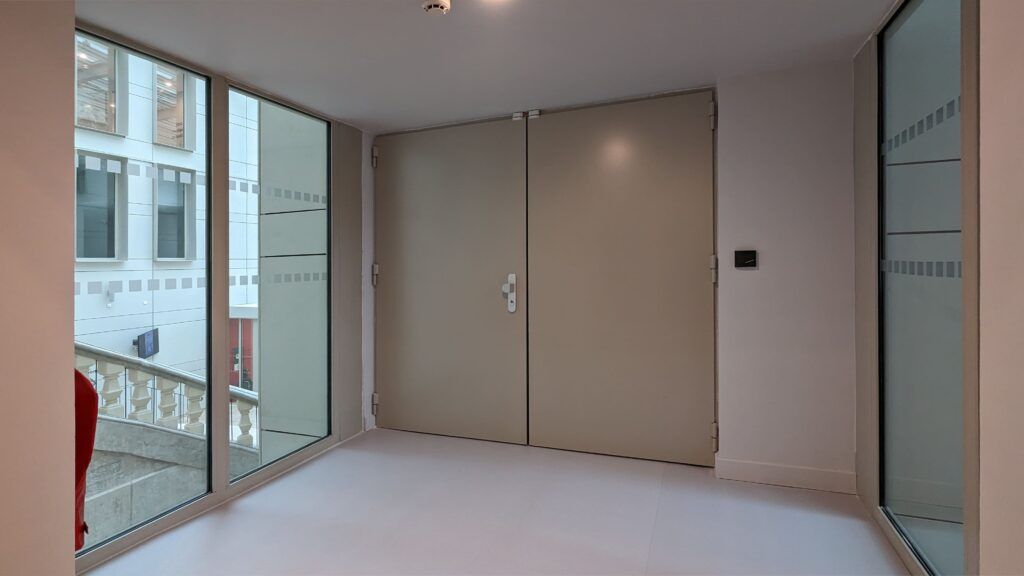 An empty room with a lot of windows and doors