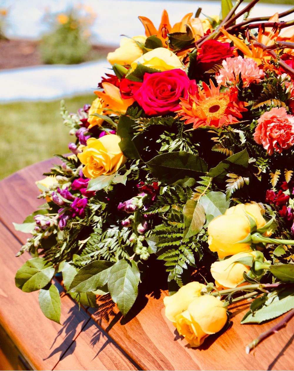 A bouquet of flowers is sitting on a wooden table.