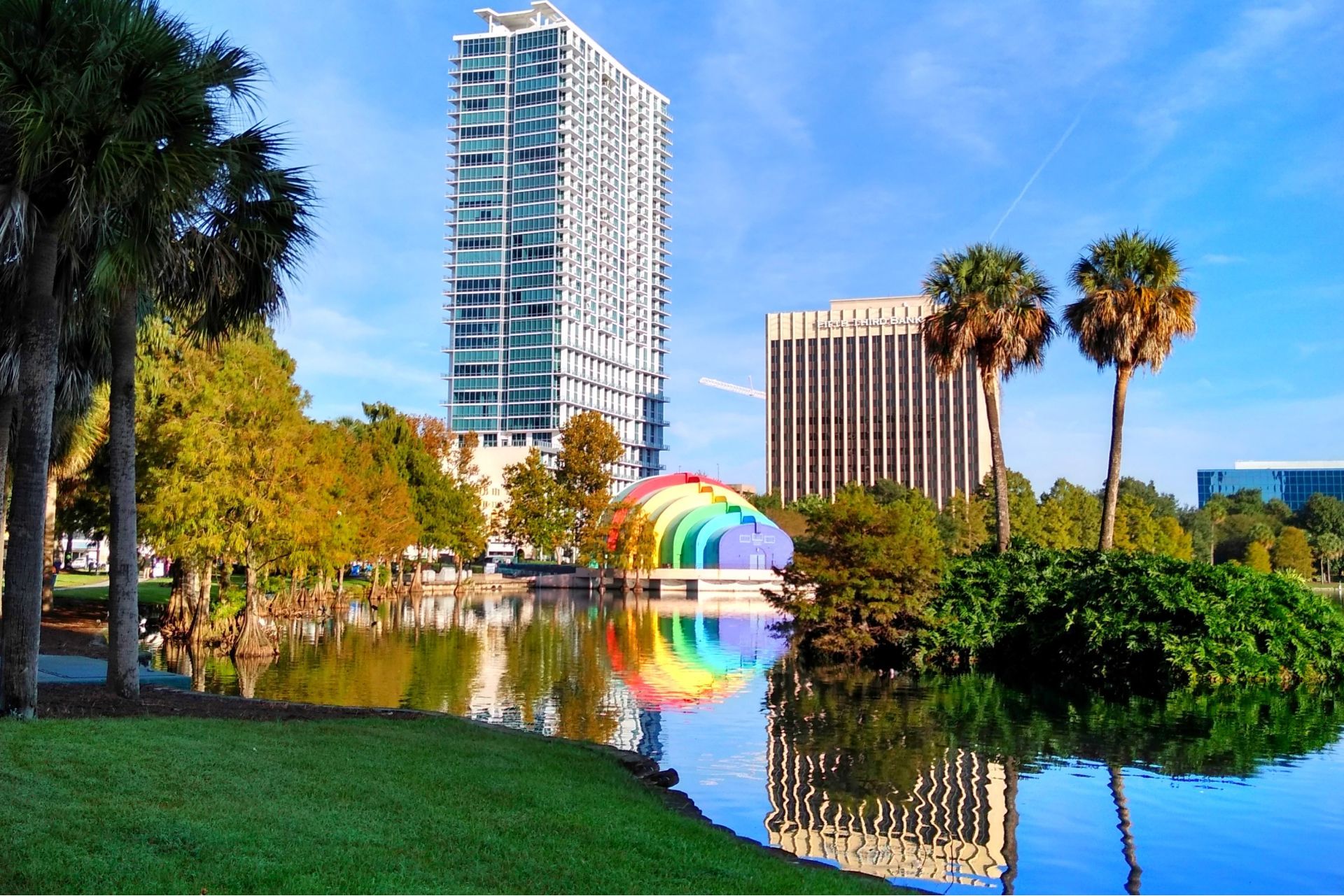 A rainbow is reflected in the water of a lake