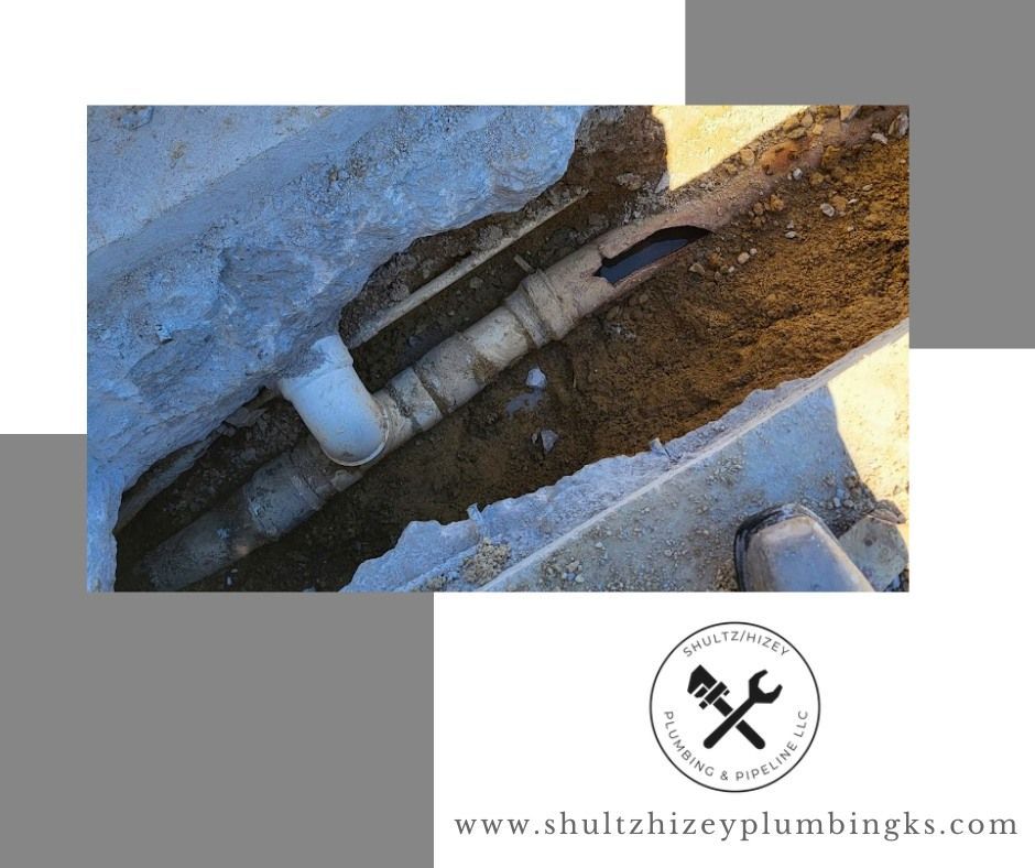 A damaged pipe in a trench, likely needing repair.