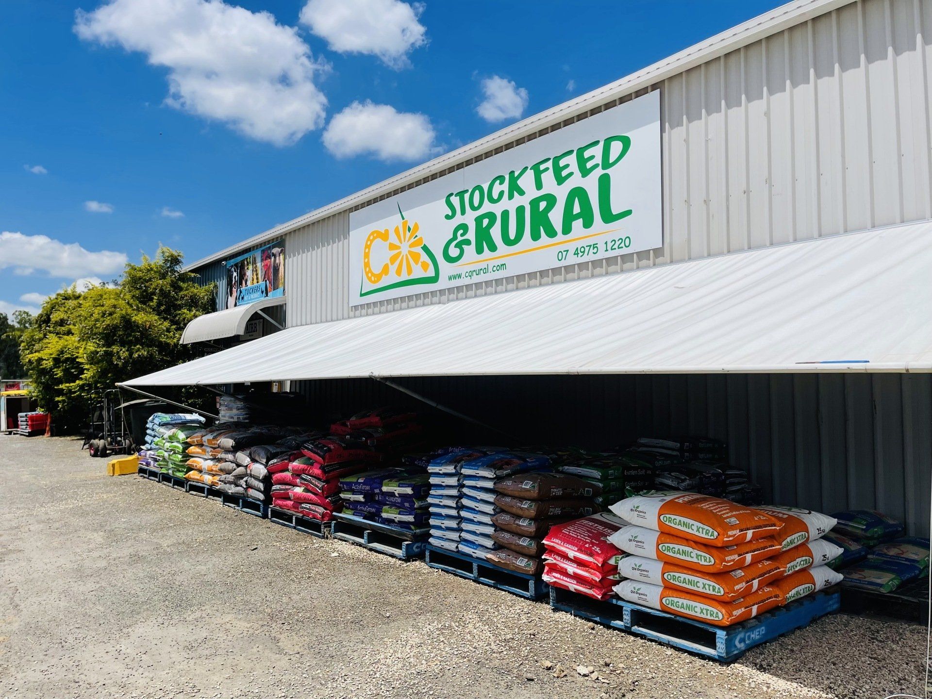 A building with a sign that says stock feed & rural on it.
