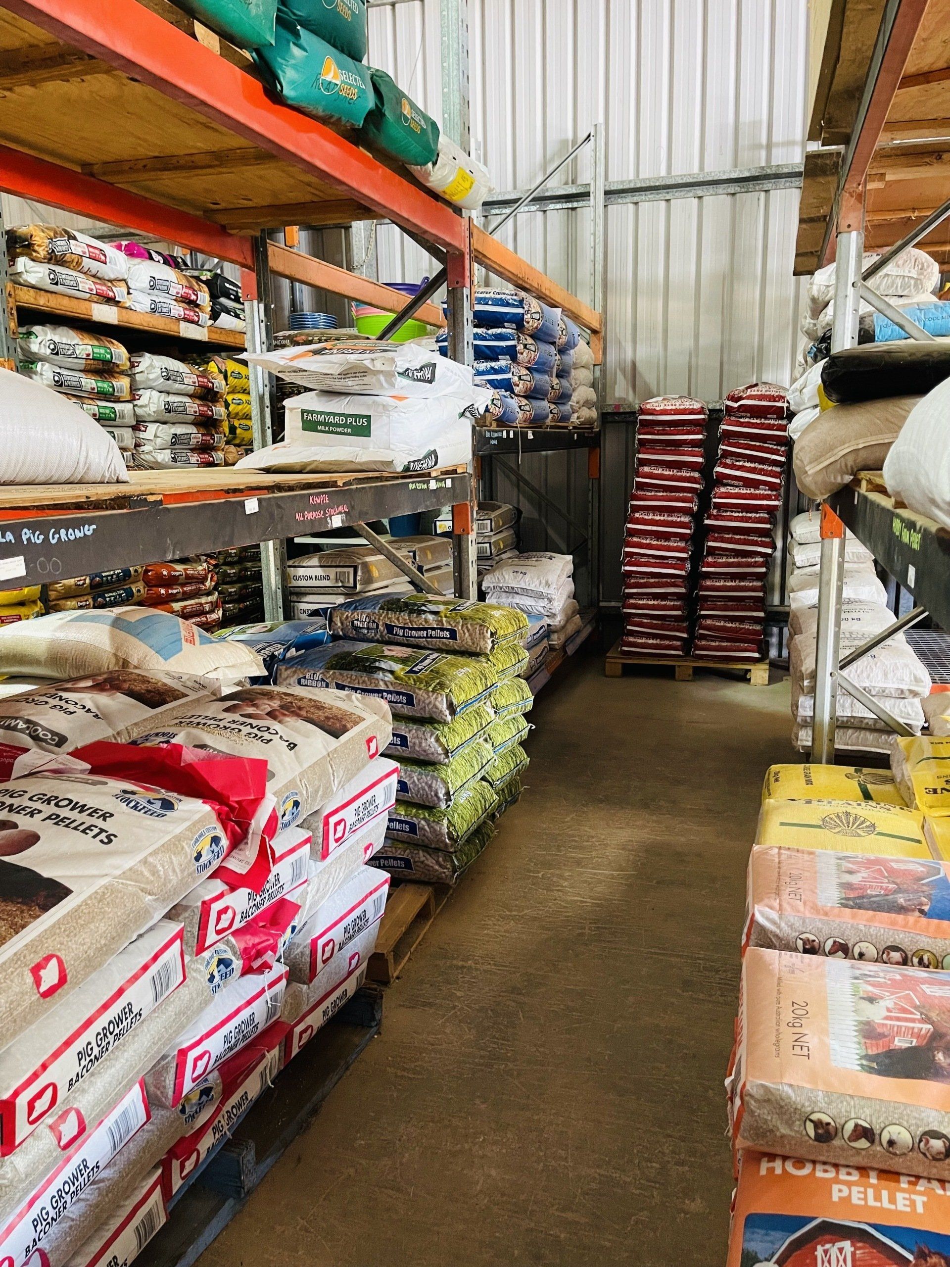 A warehouse filled with lots of bags of dog food.