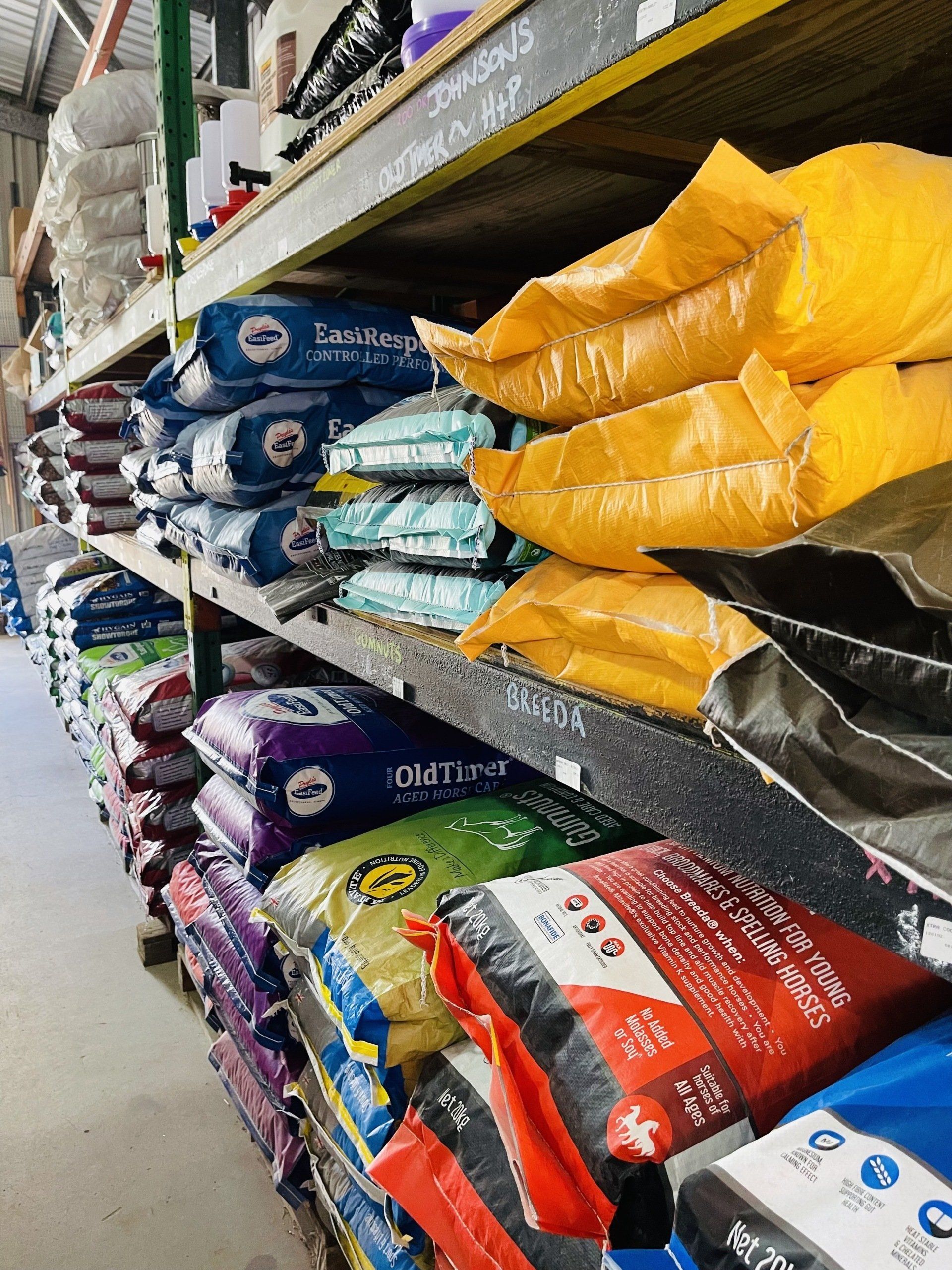 A shelf filled with bags of dog food in a store.