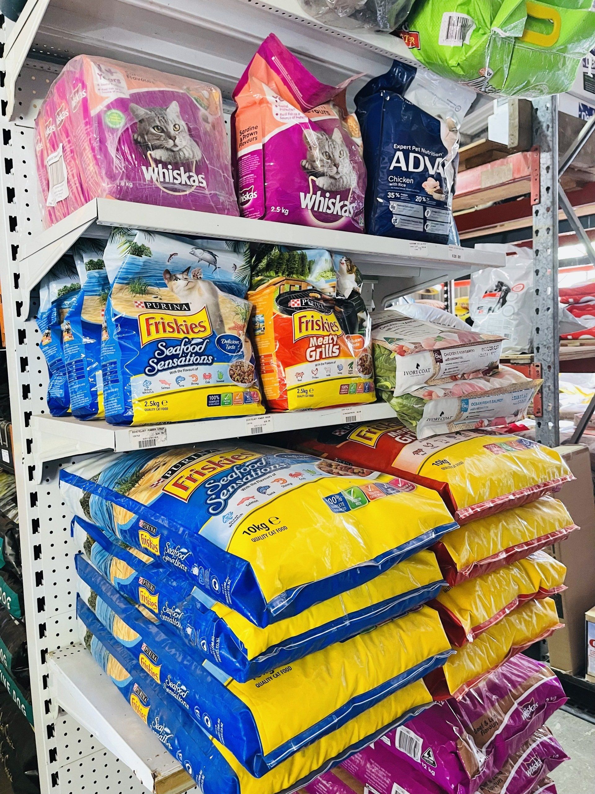 A shelf filled with bags of cat food in a store.