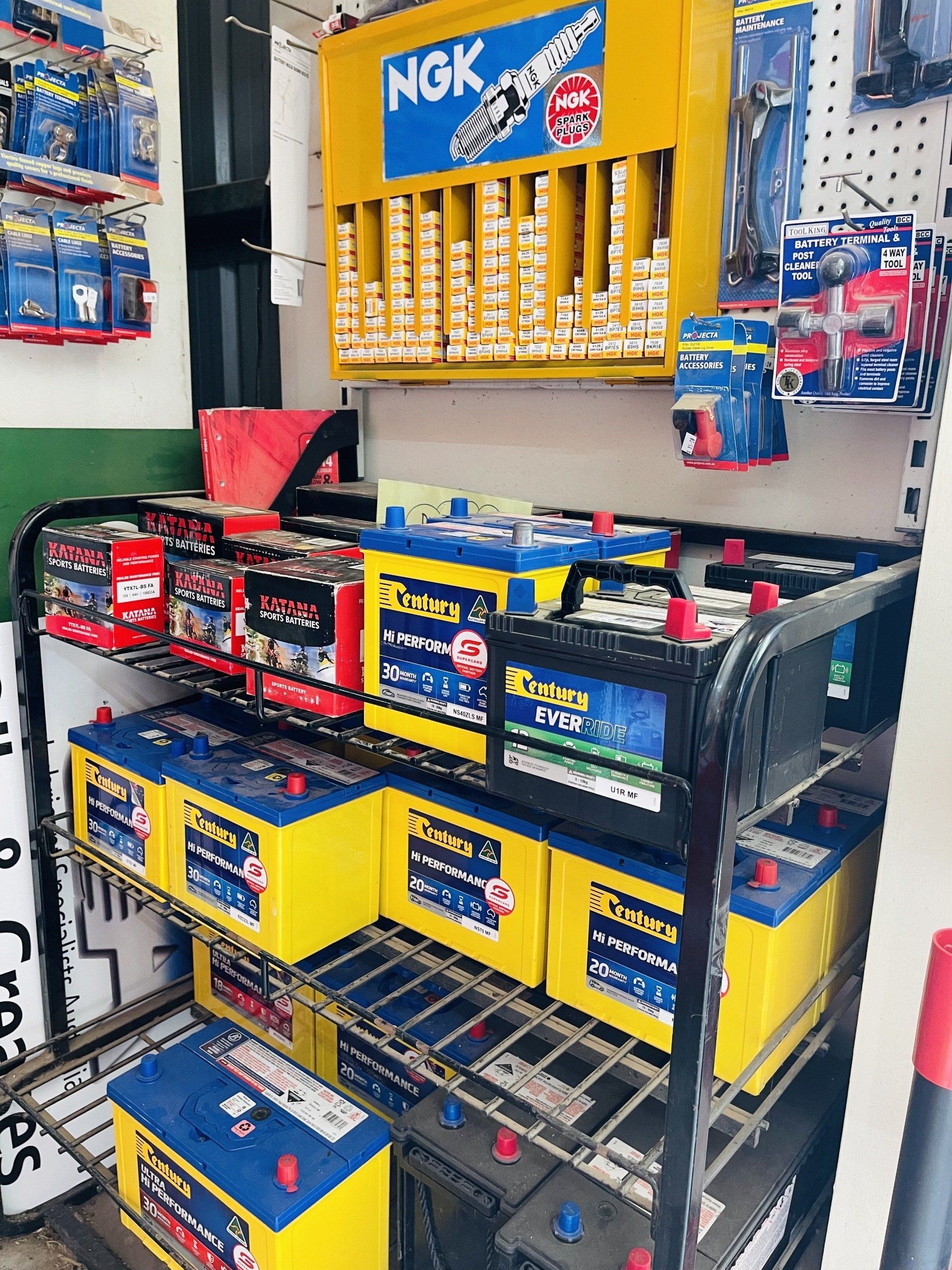 A display of batteries and spark plugs in a store.