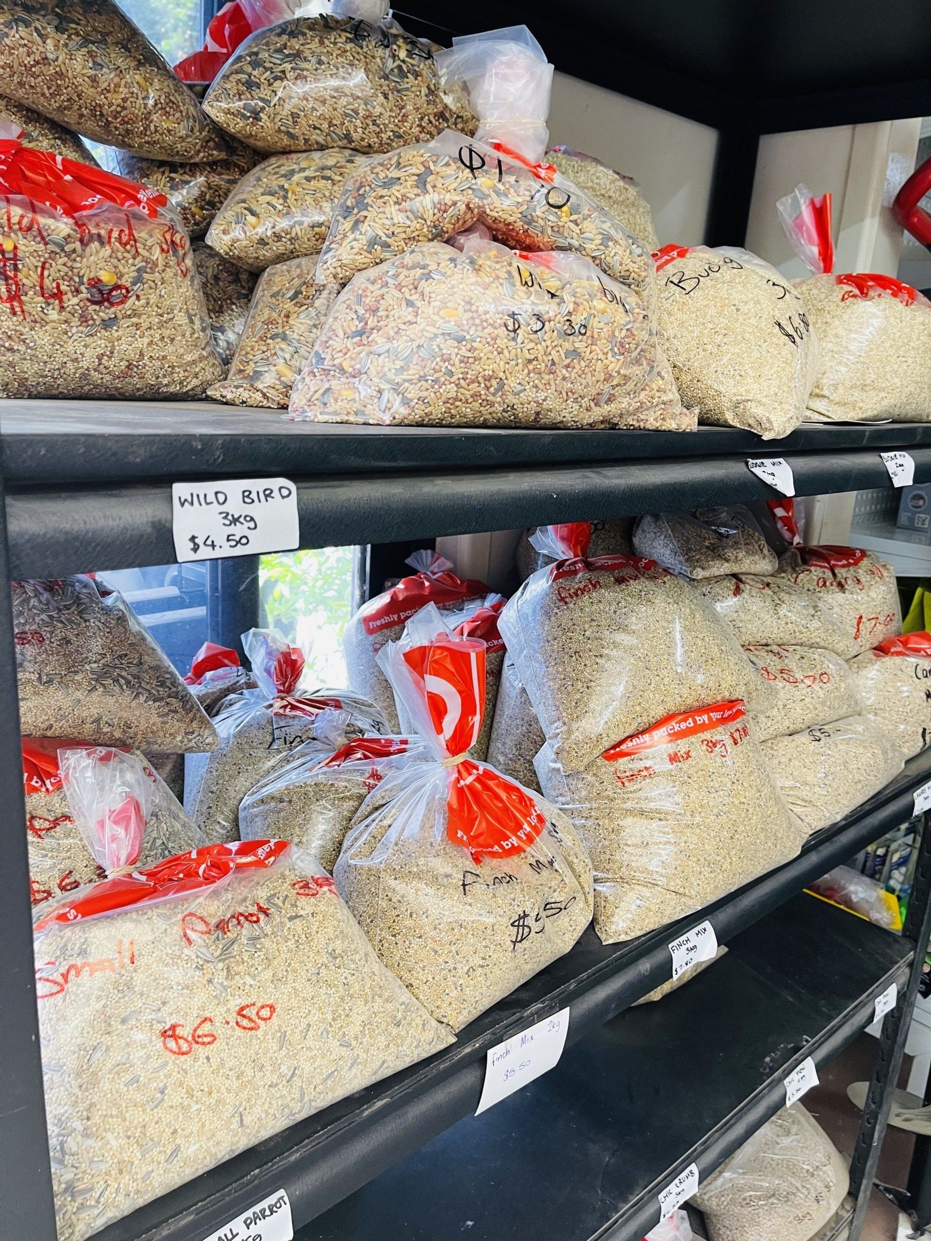 A store shelf filled with bags of rice and grains.
