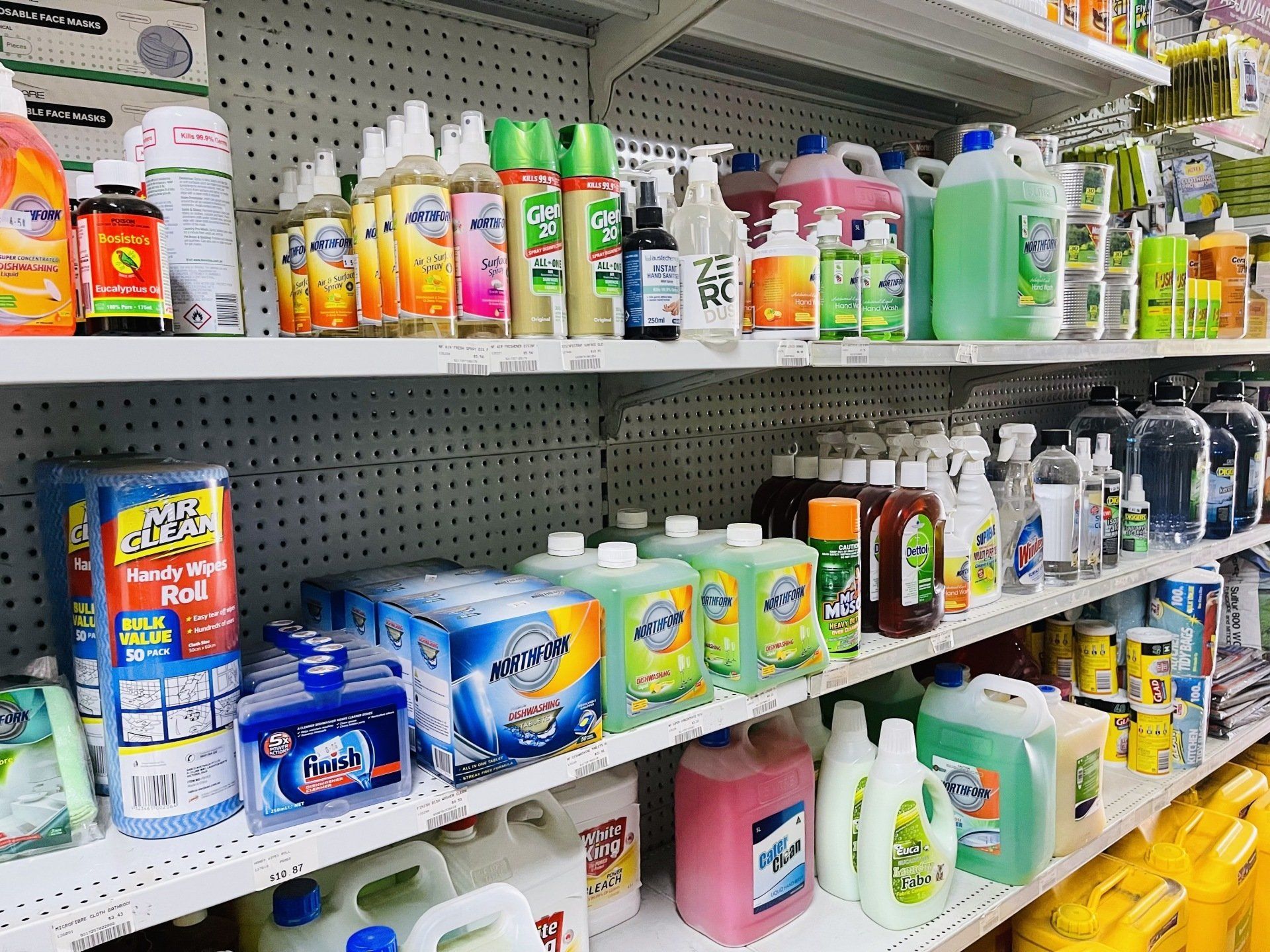A store shelf filled with lots of cleaning supplies.
