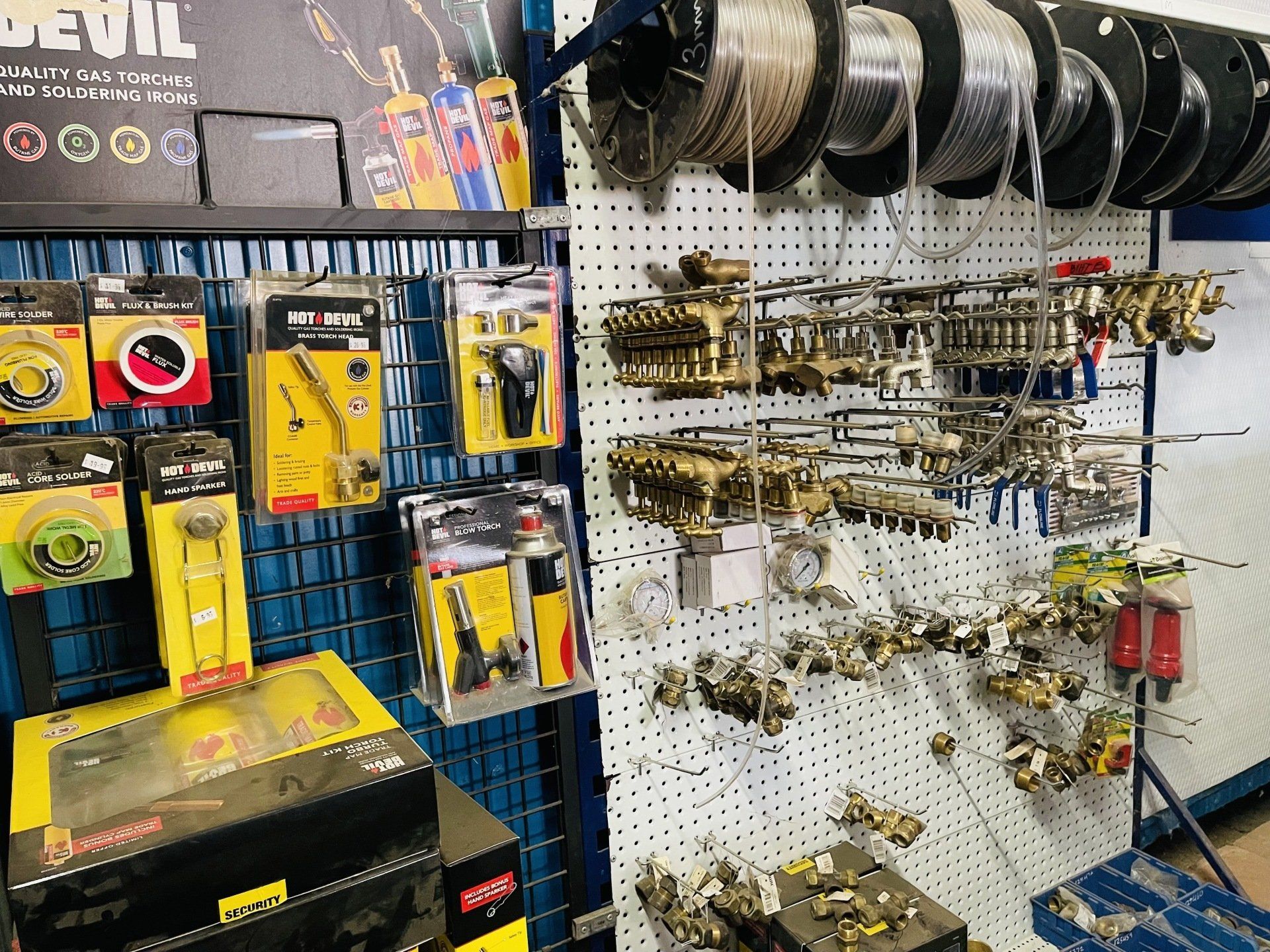 A bunch of tools are hanging on a wall in a store.