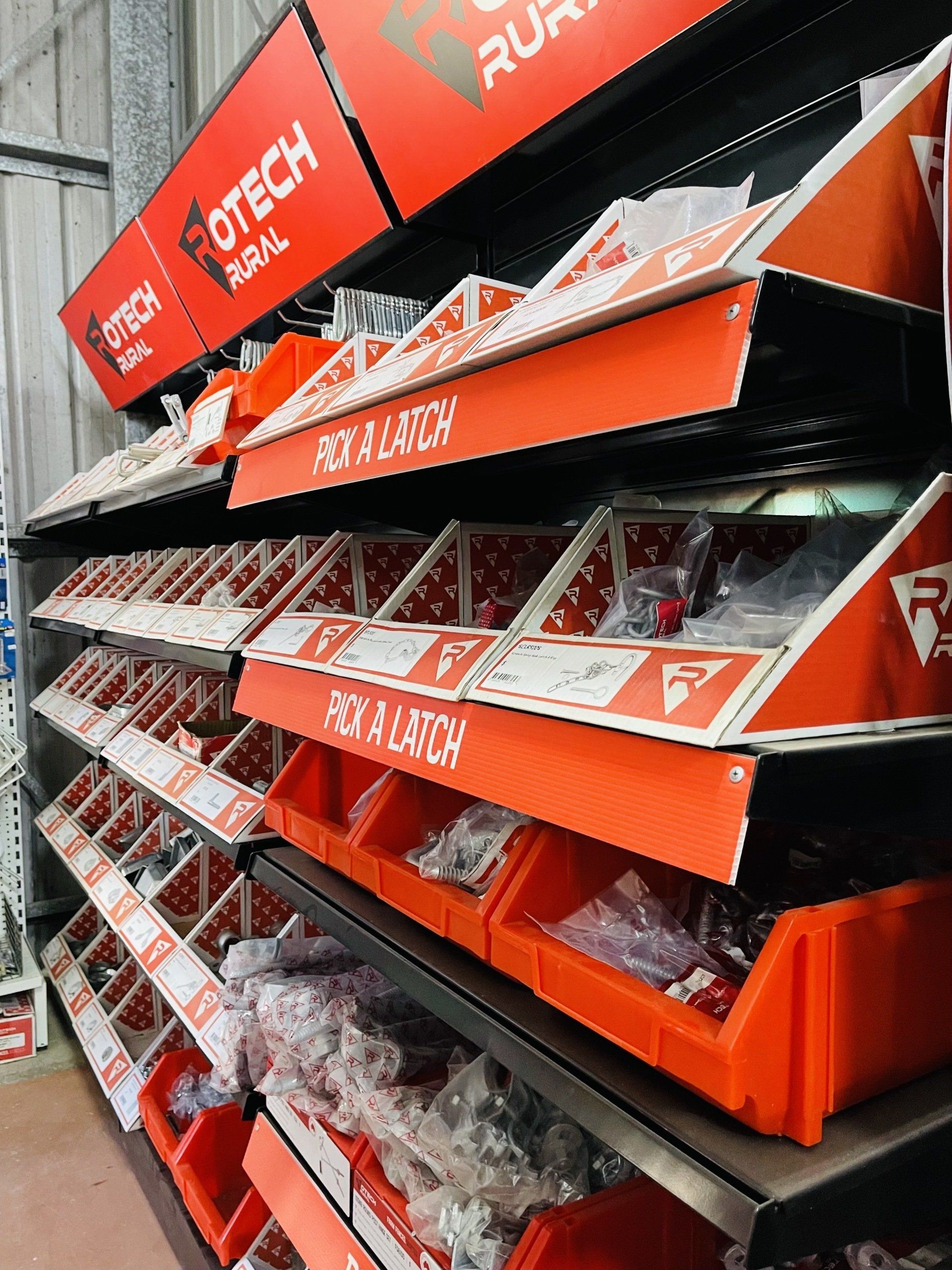 A store shelf filled with lots of orange bins and boxes.