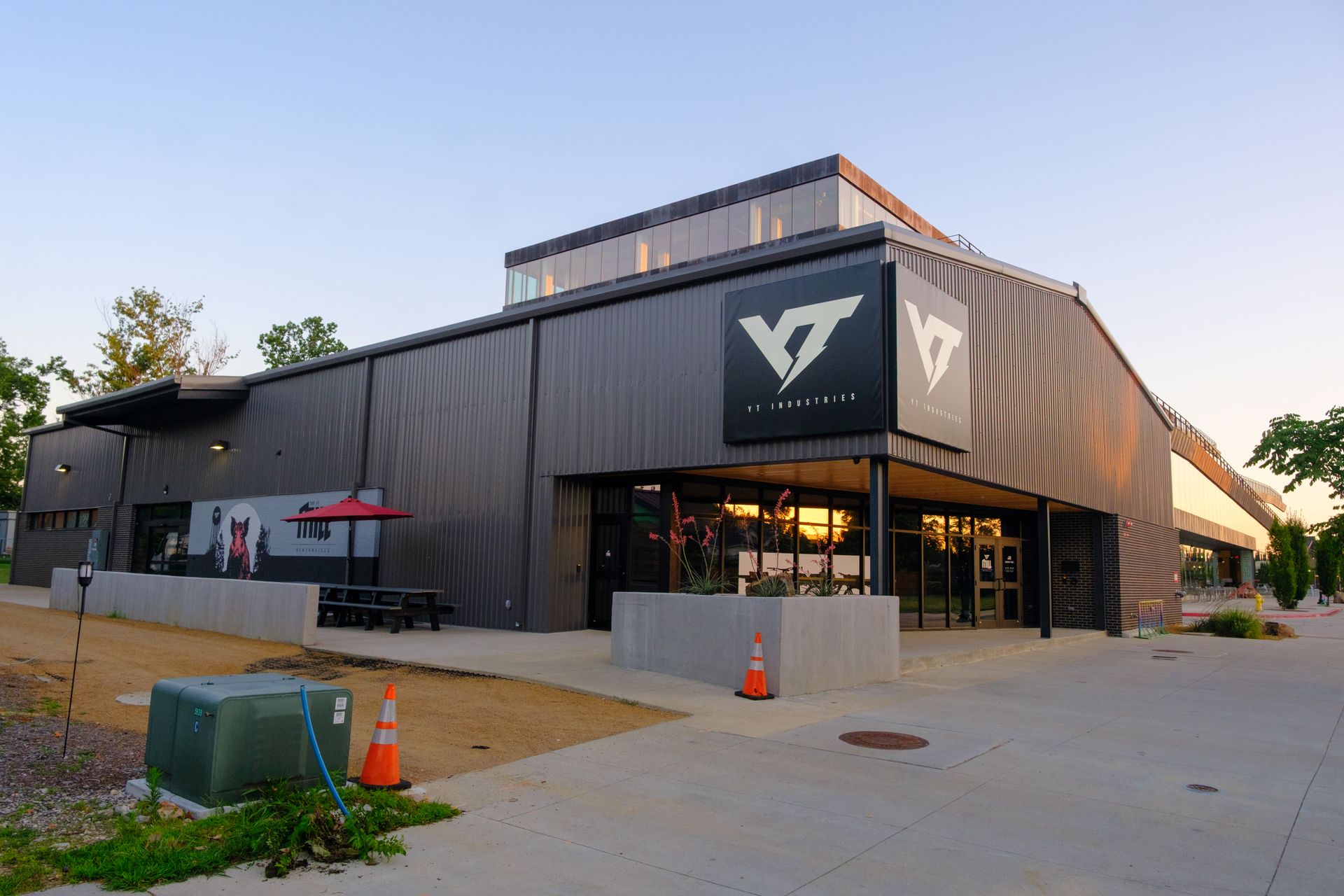 A modern, gray building with the logo 