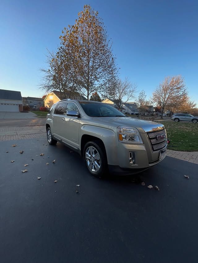 Silver SUV parked on a residential street at dusk with autumn trees and fallen leaves