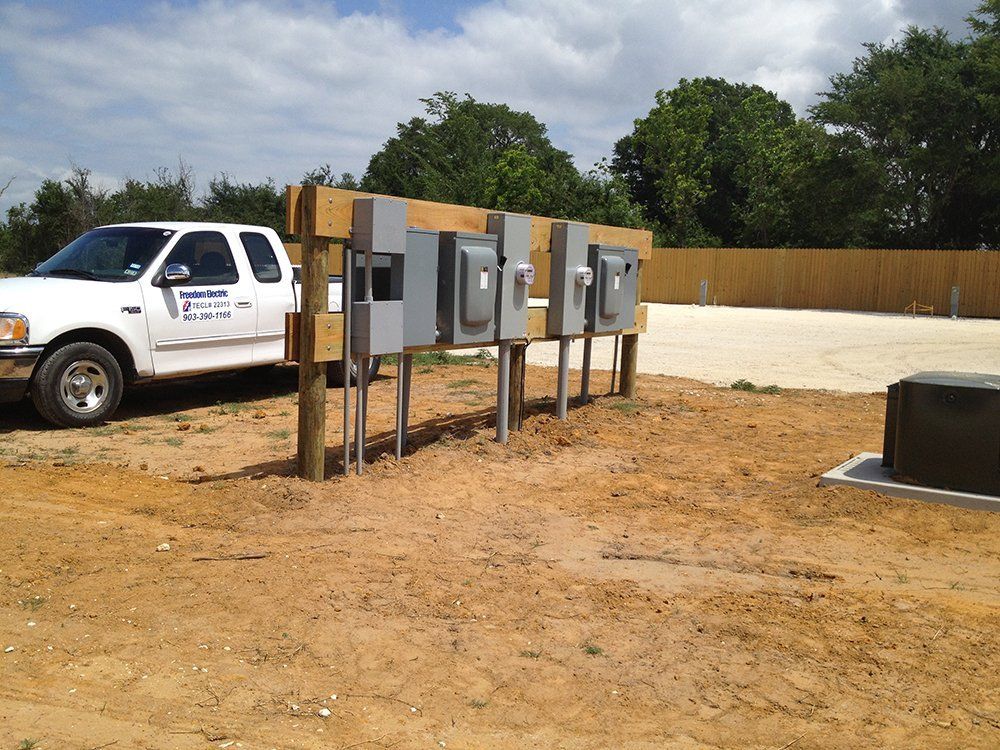 a white truck is parked next to a row of electrical boxes