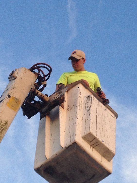a man in a yellow shirt is sitting in a lifter
