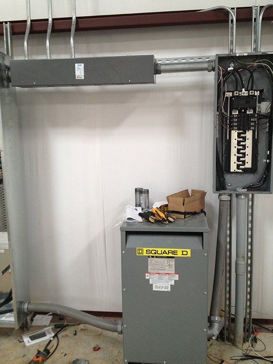 a transformer beside an electrical box inside a room