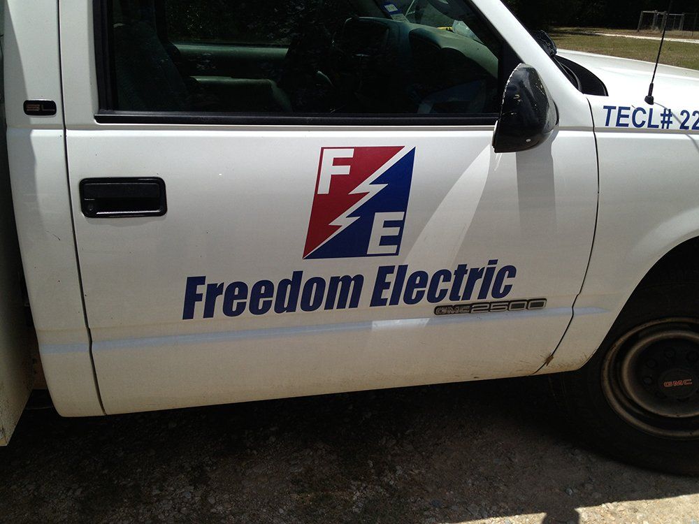 a white truck with freedom electric written on the side