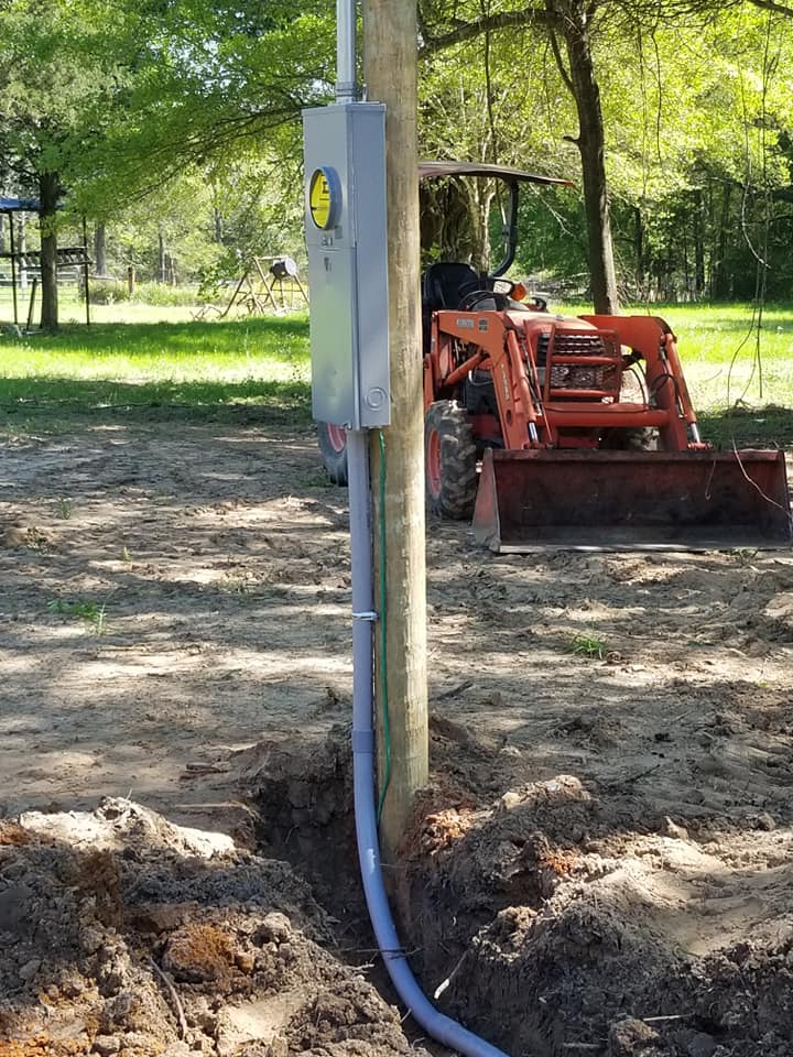 an electrical box on a pole on the ground