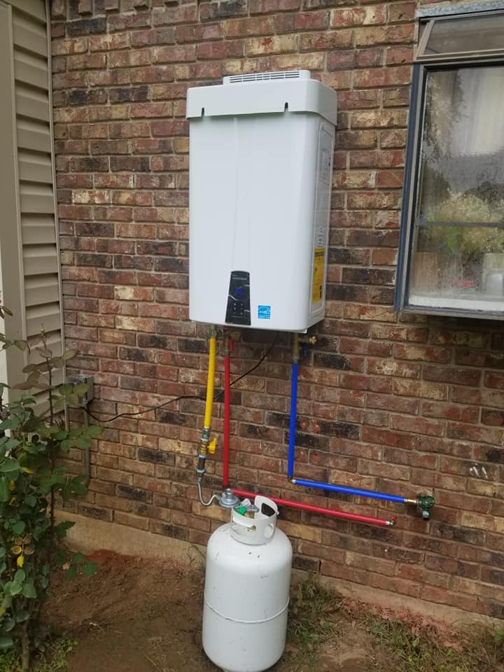 a propane tank is attached to a water heater on a brick wall .