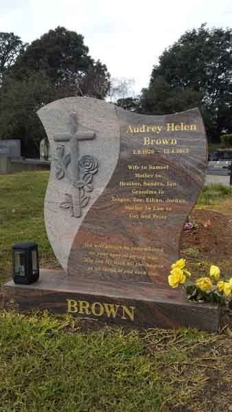 concrete custom headstone with cross and flowers