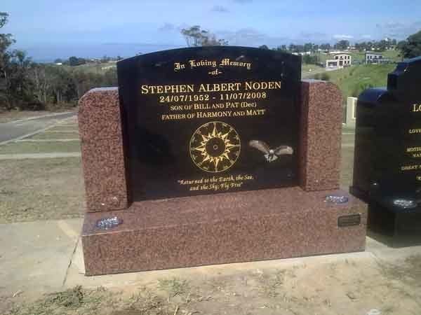 brown and black headstone with gold writing