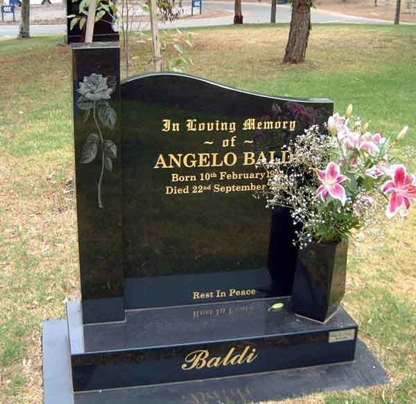 headstone with white flower on it