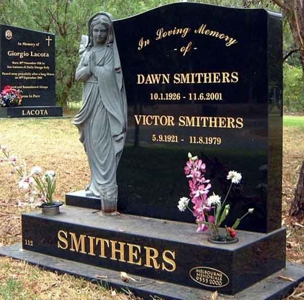 headstone of concrete angle and flowers