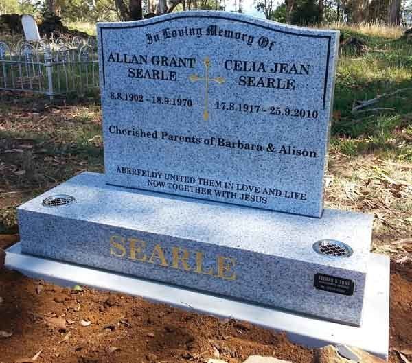 light granite headstone with gold cross