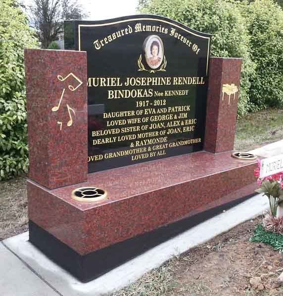 red headstone with gold music notes