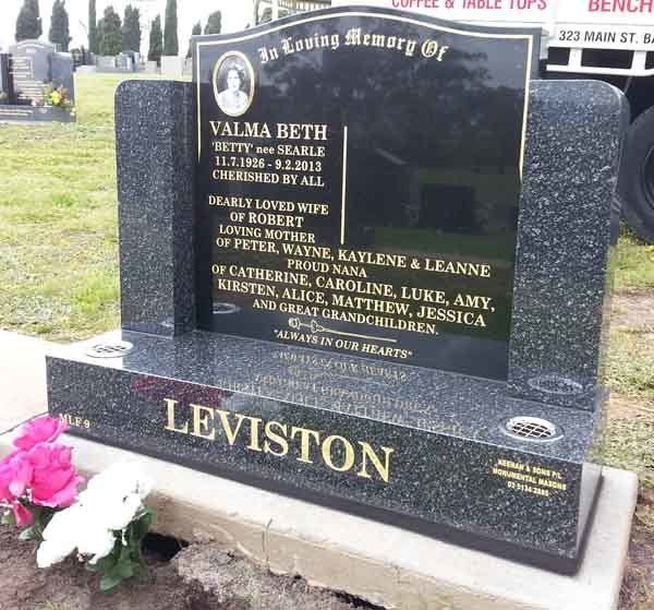 gold writing on headstone