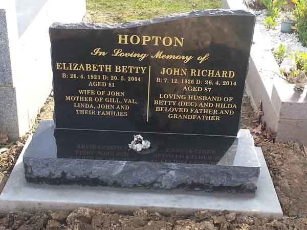 gold writing on headstone