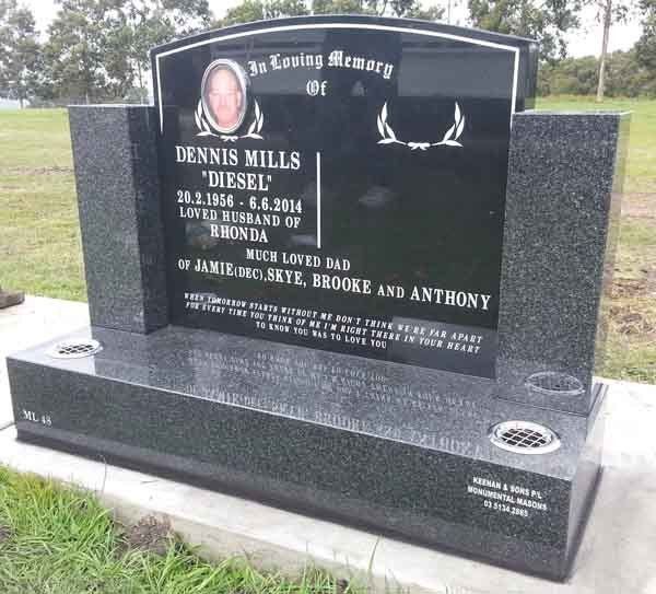 grey headstone with gold writing and picture