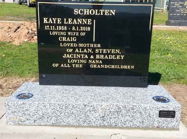 grey and black headstone with gold writing