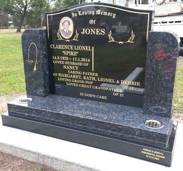black headstone with gold writing and picture
