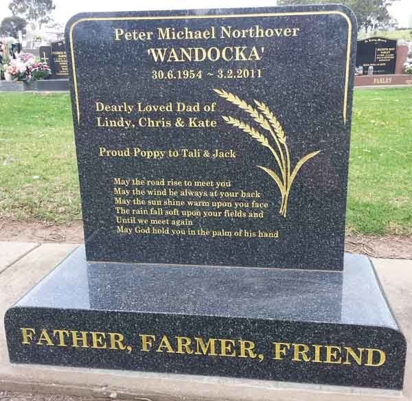 black headstone with gold writing
