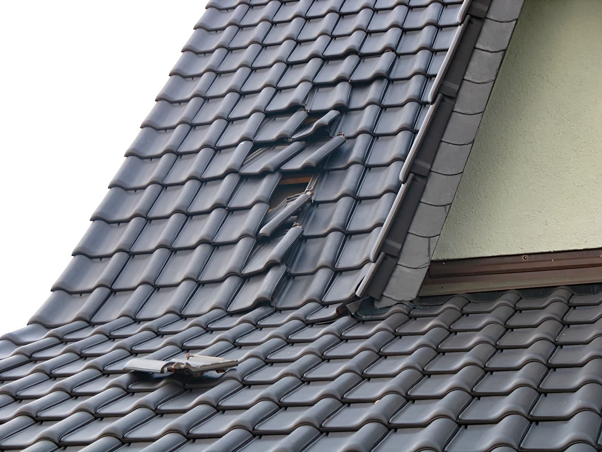 A roof with a window in the middle of it.