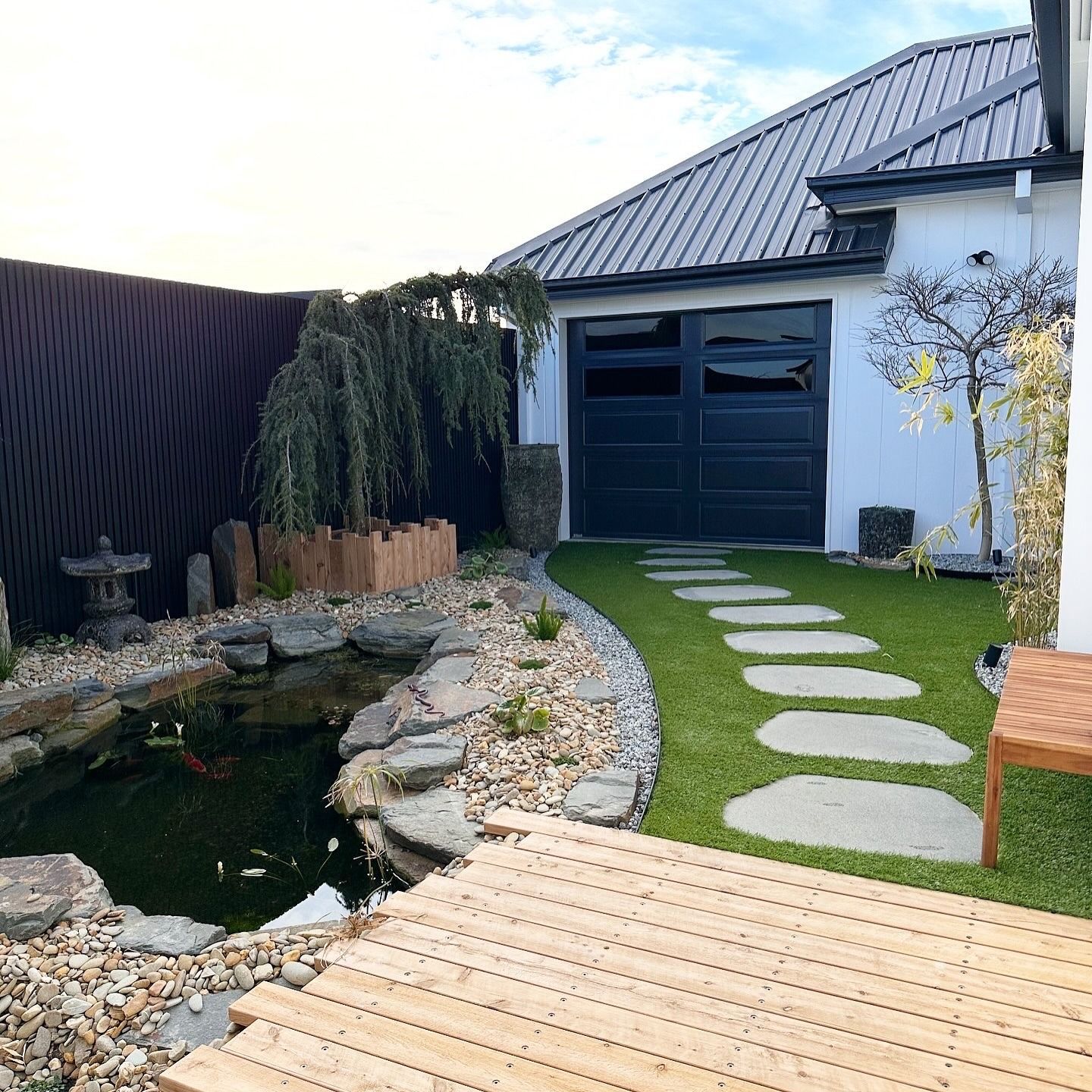 Japanese-style garden with a koi pond, stepping stones, and a garage — MGP Landscaping in Geelong, VIC