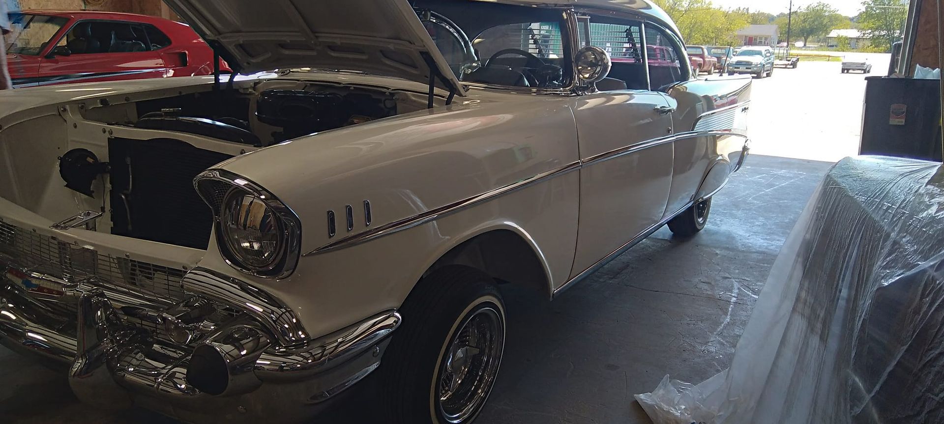 hood popped on a white vintage car 