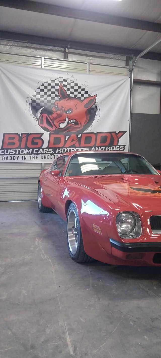 red vintage car in the Big Daddy Customs shop 