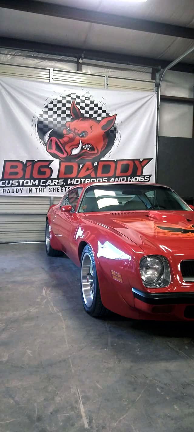 vintage red sports car in the Big Daddy Customs shop