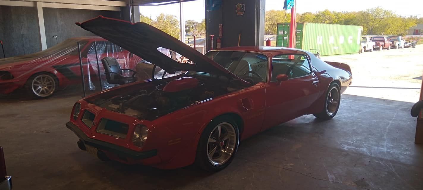 hood popped on a red car 