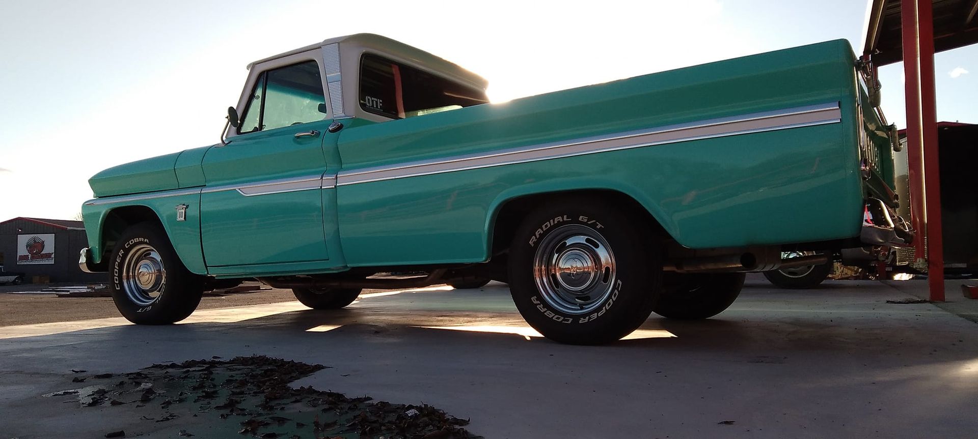 side profile of a teal vintage truck 